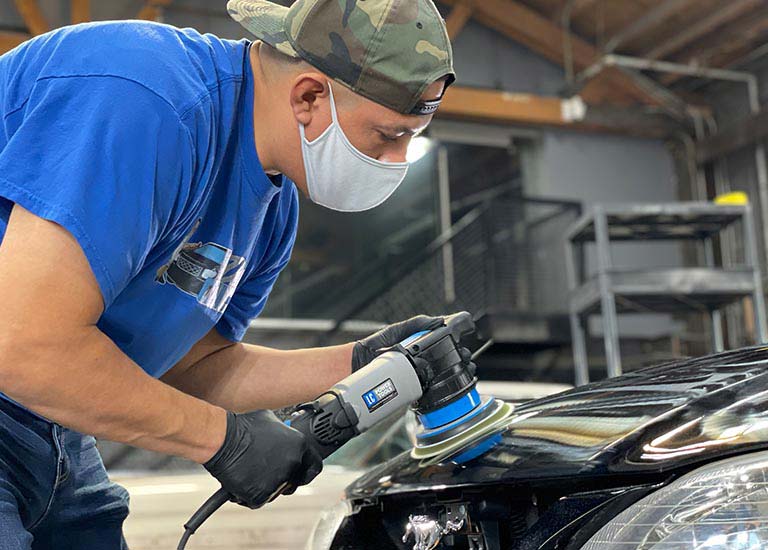 Man buffing the paint on a car